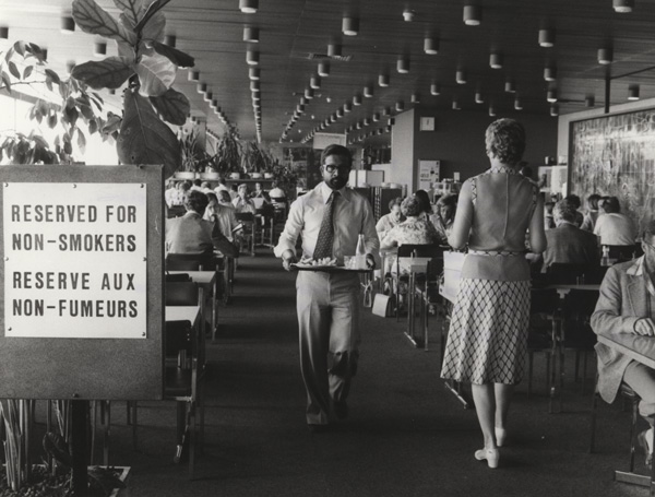 Interior view of a restaurant with a sign posted stating section: Reserved For Non-Smokers.