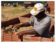 Man applies morter to brick wall