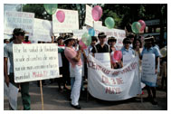 Community members gather with balloons and banners