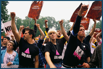 ACT UP members shout protests and hold placards