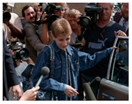 Ryan White speaks to cameramen and reporters outside his school