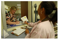 Jackson Medical Mall staff hands a prescription to patient