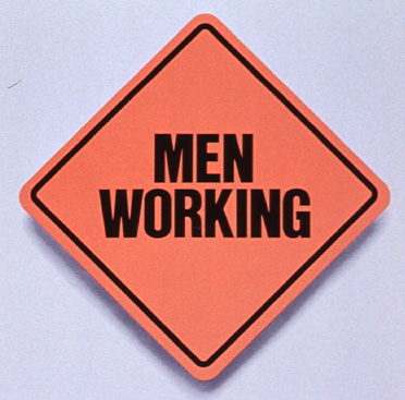 Orange square road sign that says Men Working over text