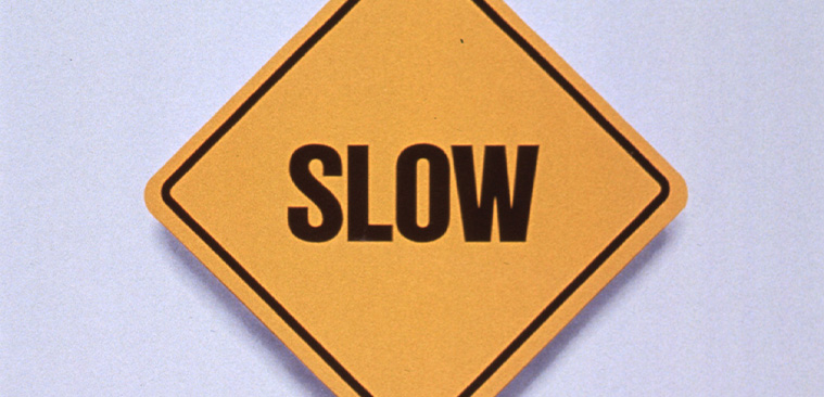 Yellow square road sign that says Slow above text