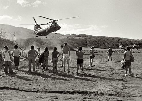 Black and white photograph of a military helicopter descends on a group of occupiers on Kaho‘olawe.