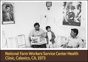 Two Latino men and one child in a clinic waiting room. The two men are seated and reading.