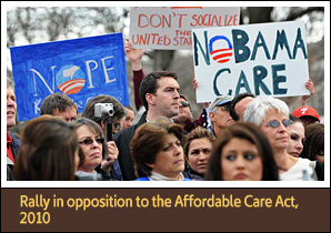 Protestors hold signs and look off to the right slightly.