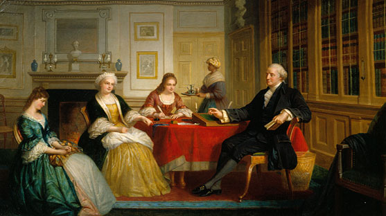 Washington Family dressed formally sitting beside a table in a room with a fireplace and bookshelf.