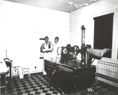 A male technician prepares to x-ray the arm of a Native American patient in the Indian Hospital Santa Fe New Mexico 1951.