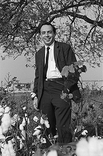 A portrait of a white man in a suit and tie outdoors.