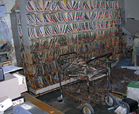 Shelves of folders and other office equipment are molded and rusted.