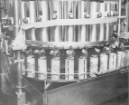 Cans of infant formula on a conveyor belt.