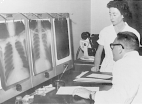 Dr. Franco Ermenegildo sits at a table with Miss Sara Maffezzoli standing next to him as they read three X-ray films.