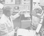 A researcher is seated in front of an atomic bombardment mass spectrometer at the FDA's Center for Biologics Evaluation and Research taking a reading from the spectrometer.