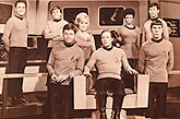 The cast of Star Trek in costume, 6 men and 2 women of various ethnic backgrounds.