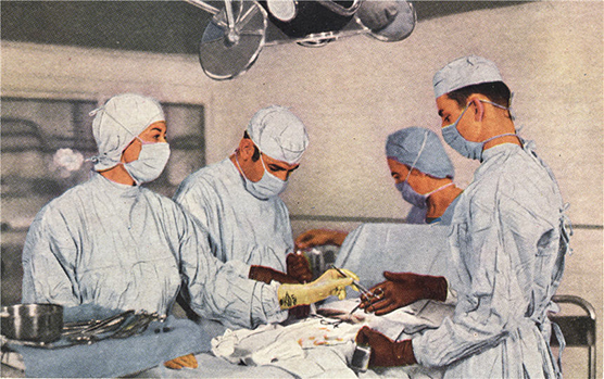 Two White male doctors and two White female nurses in the middle of an operation.