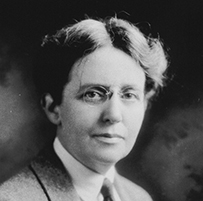 Dr. S. Josephine Baker, a White female in a shirt, tie, and suit jacket posing for her portrait. Signed photo.