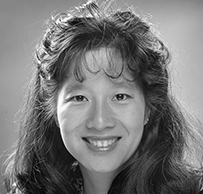 Dr. Eliza Lo Chin, an Asian female with medium length hair smiling for her portrait.