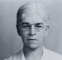 Dr. Ethel Collins Dunham, a White female wearing glasses facing straight for her portrait.