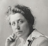 Dr. Marie Diana Equi, a female wearing a lace collared blouse and suit jacket posing for her portrait.