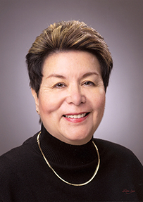 Dr. Frances McLemore Fisk, a White female in a black turtleneck smiling for portrait.