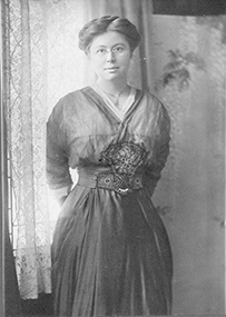 Dr. Kate Pelham Newcomb, a female in a long dress posing for her portrait.