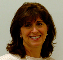 Dr. Karen Schulder Rheuban, a smiling White female with brown hair and pearls posing for her portrait.