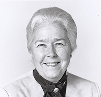 Dr. Marjorie Spurrier Sirridge, a White female in a scarf, smiling for her portrait.