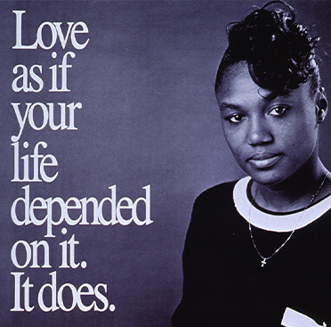 Black and white photograph of an African American woman sitting down and looking at the viewer.