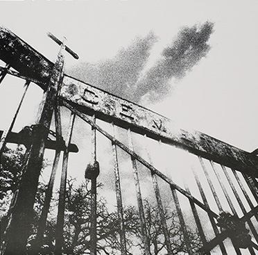 Black and white photograph of front iron gates with “Cemetery” above gates.   