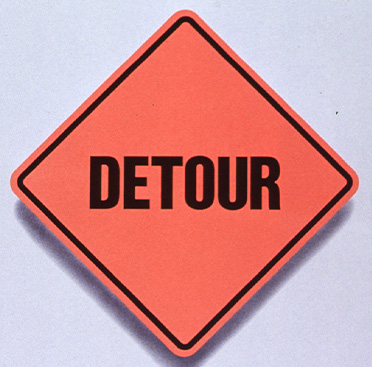 Orange square road sign that reads “Detour” over text