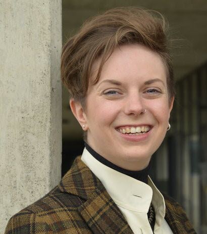 Photograph of a woman with windows in the background