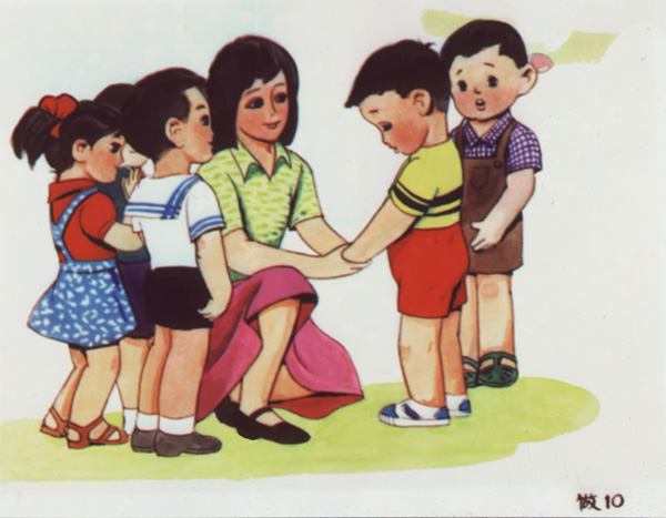 Slide showing a boy, wearing red shorts and a yellow and black shirt, standing in front of his teacher with his head bowed and speaking to her as another boy, in brown overalls and checkered shirt, and other children look on