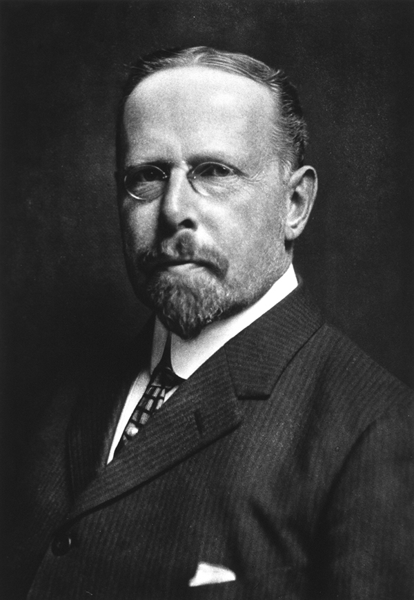 Formal Photogravure of a white man in a suit with a beard and glasses.