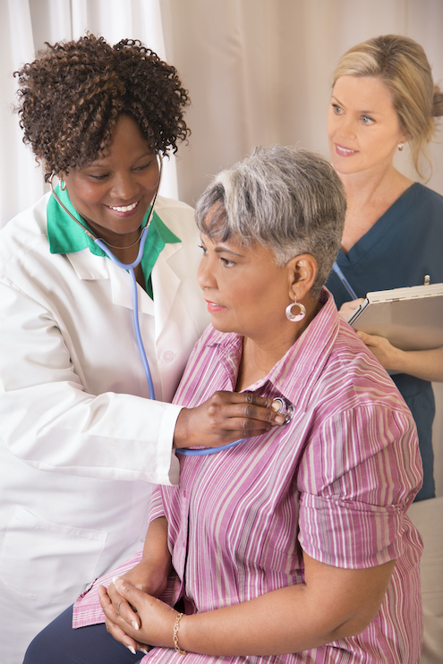 Doctor with older patient and nurse watching on.